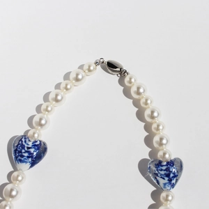 Blue porcelain heart pearl necklace featuring white round beads and silver lobster clasp