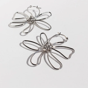 Minimalist silver floral drop earrings with hollow 3D metal petals for stylish women