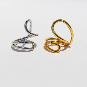Abstract geometric twisted metal ring in polished silver and gold finishes