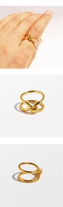 Detailed views of gold knot ring showing double twisted ropes on a person and isolated