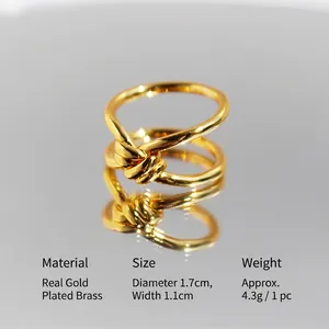 Polished gold double-layer knot ring with elegant mirror reflection on gray background