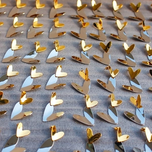 Macro shot of gold and silver mixed metal heart earrings with mirror finish
