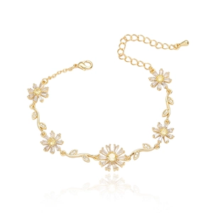 Elegant gold flower bracelet with emerald daisy links and white zircon petals on white background