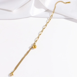Macro detail of gold stainless steel bracelet featuring round bead and S.Steel hallmark