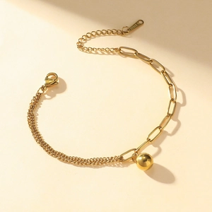Gold stainless steel paperclip chain bracelet featuring a polished round ball pendant