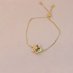 Detail of adjustable gold floral bracelet featuring colorful marquise zircon petals