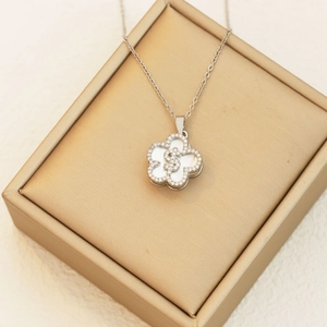 Silver flower pendant necklace with white mother-of-pearl and crystal dollar sign detail
