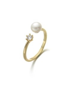 Close-up of gold open ring with round white pearl and zircon stone in six-prong setting