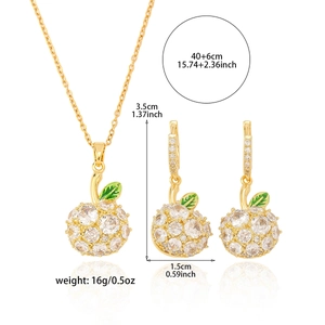 Parure bijoux pomme dorée avec cristaux clairs et détail de feuille verte