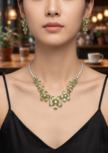 Macro detail of plum blossom jewelry set with olive green and yellow zircon stones