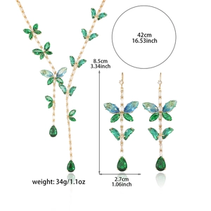 Golden necklace and earring set with green butterfly crystals and teardrop pendants