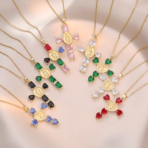 Cross necklace with multicolored zircons and Virgin Mary pendant on silk background