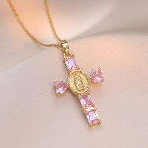 Detailed close-up of a gold cross pendant with pink zircons and Virgin Mary relief