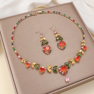 Luxury gold jewelry set with colorful heart-shaped red gems and teardrop stones