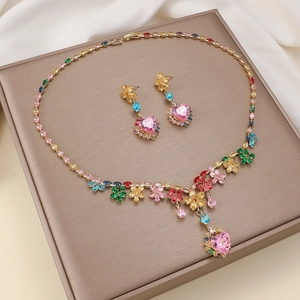 Luxurious gold jewelry set with colorful heart gemstones and floral necklace and earrings