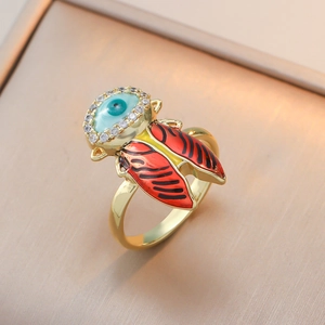 Evil eye ring with red enamel insect wings and sparkling crystals in gold finish