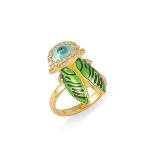 Macro detail of insect ring with green enamel wings and devil eye crystal design