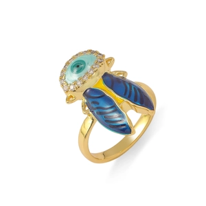 Macro detail of golden insect ring with blue evil eye stone and crystal accents