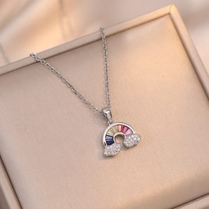 Rainbow cloud pendant necklace with colorful gems and sparkling crystals on silk background