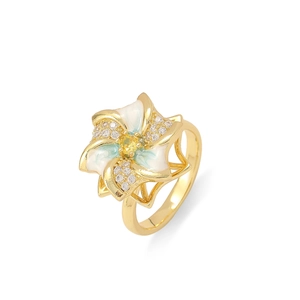 Detailed macro view of rotating flower pendant with enamel petals and yellow gemstone