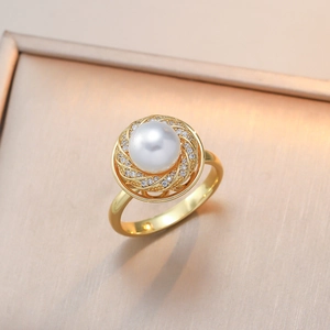 Elegant gold pearl ring featuring a central white pearl and spiral zircon embellishments