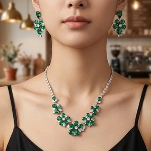 Emerald flower jewelry set with necklace and earrings on model in cafe setting