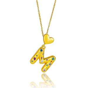 Détail du pendentif lettre M dorée serti de cristaux colorés sur une chaîne délicate