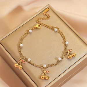 Elegant gold titanium steel double-layer bracelet with cherry charms and pearls