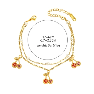 Double-layered gold titanium bracelet with crystal cherry charms and pearls
