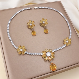 Luxury silver flower jewelry set with yellow pear-cut crystals and pendant earrings