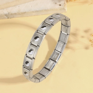 Macro detail of Italian charm bracelet with Yin-Yang enamel modules in stainless steel