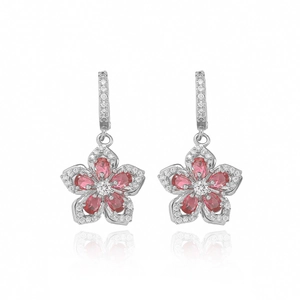 Macro detail of silver flower earrings with red petals and sparkling white zircons