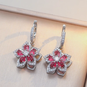 Elegant rotating five-petal flower dangle earrings with red zircon in silver finish