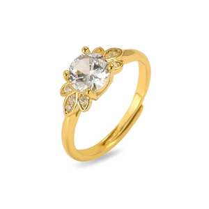 Macro view of gold flower ring featuring a sparkling white zircon and detailed side leaves