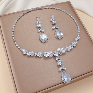 Elegant zircon tulip necklace and teardrop earrings set on a premium leather display