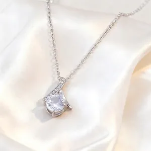 Elegant silver ribbon pendant necklace with a large round cubic zirconia stone