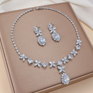 Elegant silver-toned necklace and earring set with butterfly zircon clusters on silk
