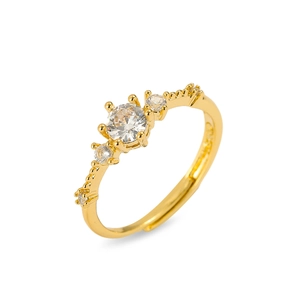 Adjustable gold ring featuring three clear zircons and delicate beaded edge detailing