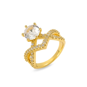 Macro shot of gold-plated ring featuring a large round zircon and criss-cross pave band