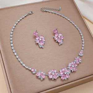 Pink zircon floral necklace and earrings set on a premium jewelry display board