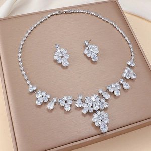 Elegant silver-toned flower necklace and earrings set with teardrop zircon stones