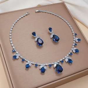 Blue tulip zircon jewelry set with pear-cut necklace and earrings on silk background