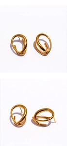 Macro view of geometric twisted gold-plated brass earrings with polished finish