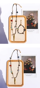 Dettaglio di collana e bracciale bohémien con perline occhio di tigre e ciondolo pesce