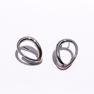Modern silver geometric twisted drop earrings with minimalist liquid metal curved design