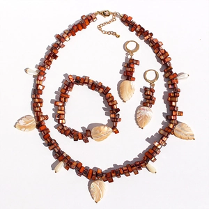 Three-piece jewelry set with brown beads and white mother-of-pearl leaf pendants