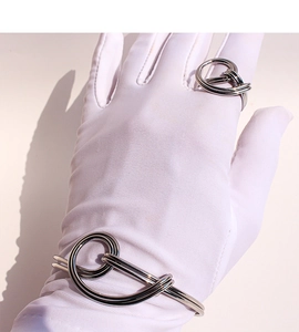 Close-up of silver knot cuff bracelet and matching double-layered wire knot ring set