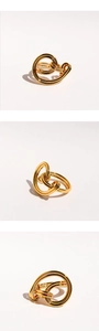 Detailed close-up of gold interlocking knot ring with multi-layered spiral design