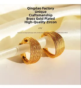 Detailed view of layered gold-plated brass hoop earrings with zircon stones on silk