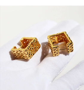 Detail of gold woven mesh square hoop earrings with intricate hollow metal craftsmanship
